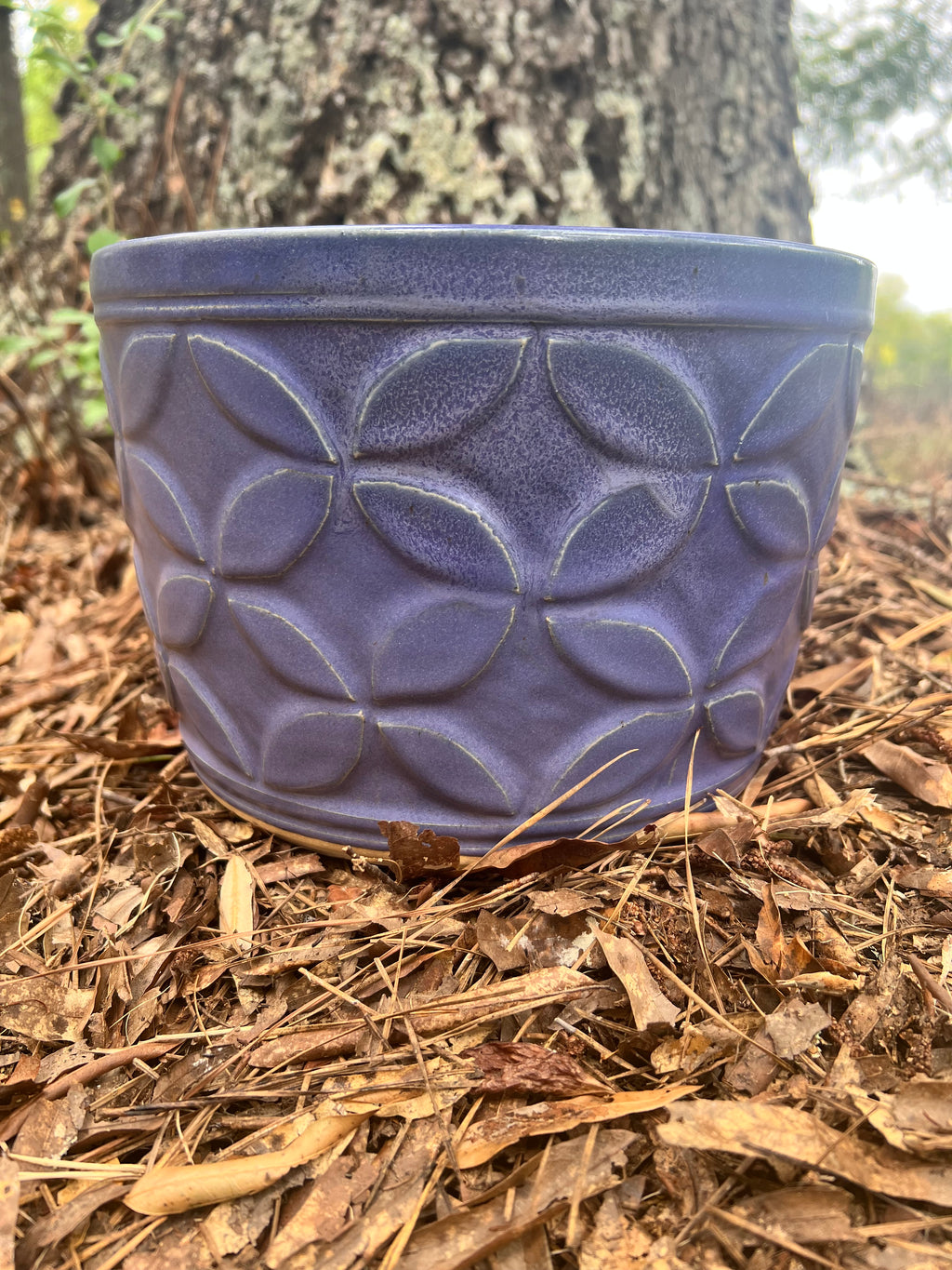 large violet hand carved planter